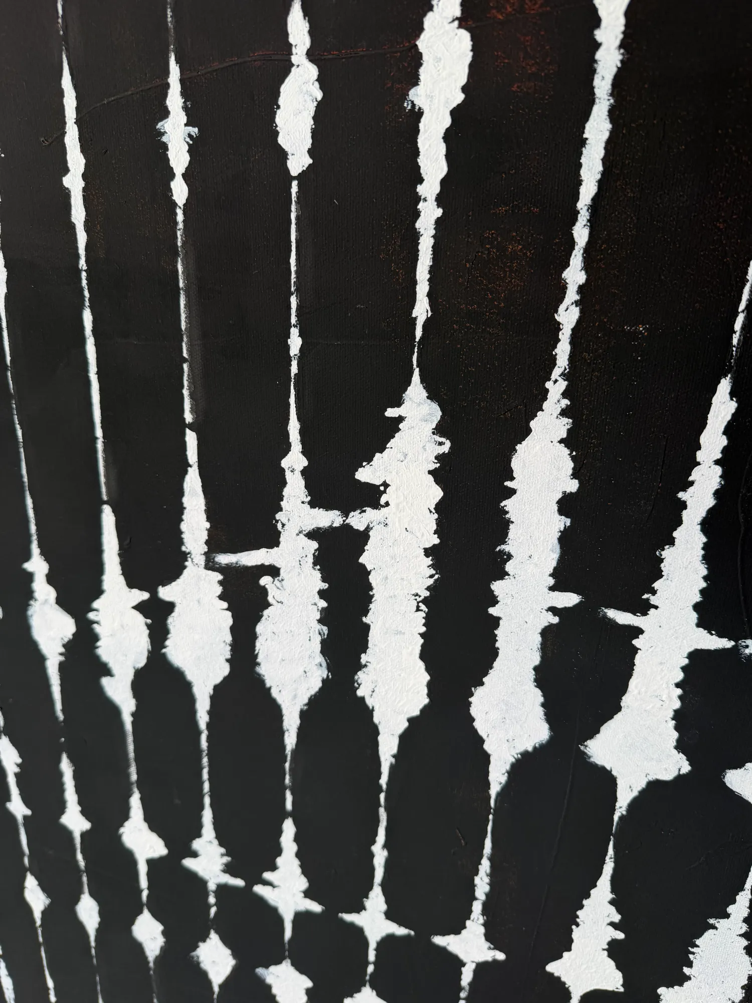 Side view of Tribal anamorphic painting revealing the hidden portrait