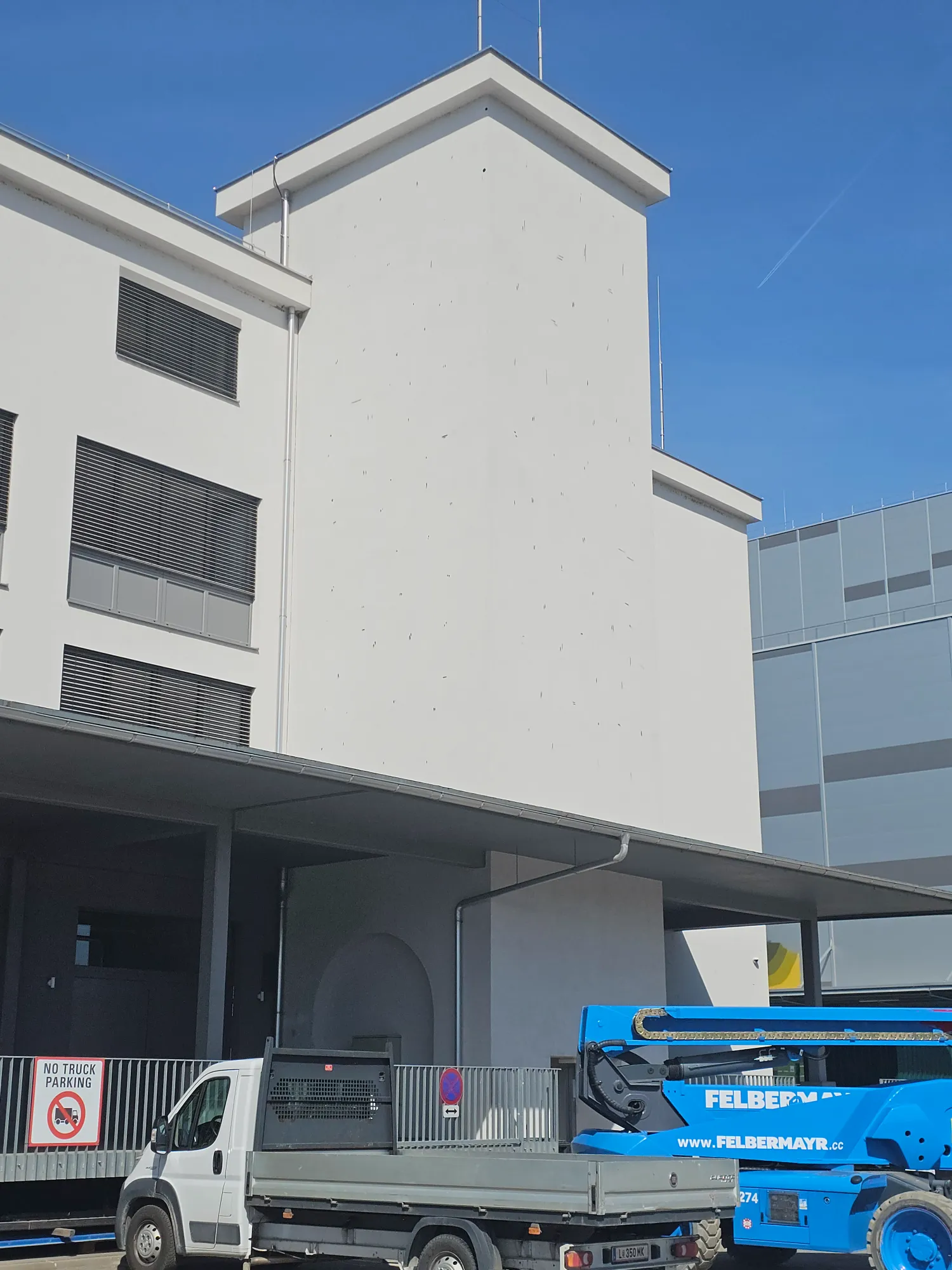 Anamorphic chrome drop painted by Odeith on an industrial building at Mural Harbor Linz