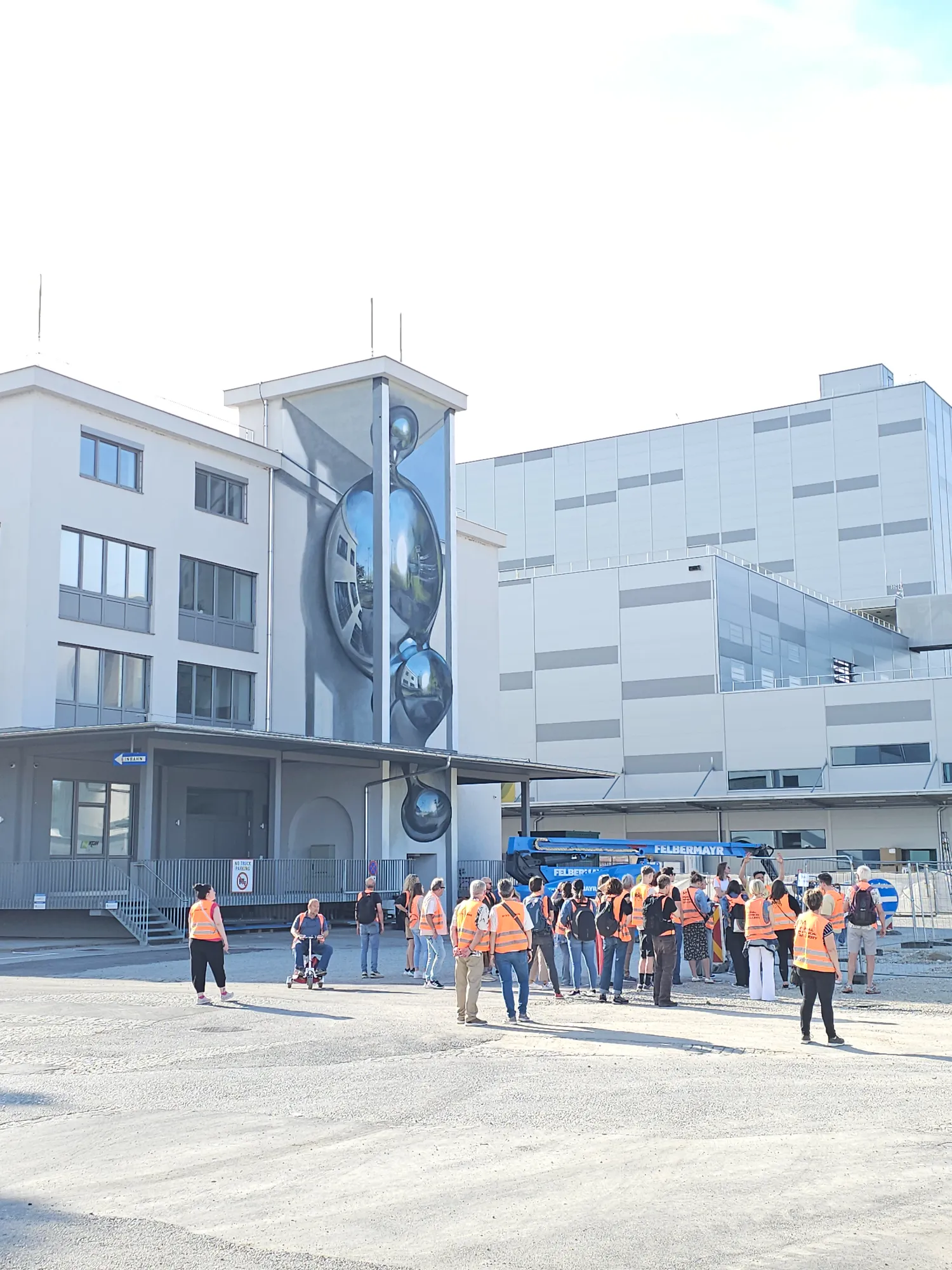 Odeith mural transforming a vertical industrial structure into a three-dimensional chrome sculpture in Linz