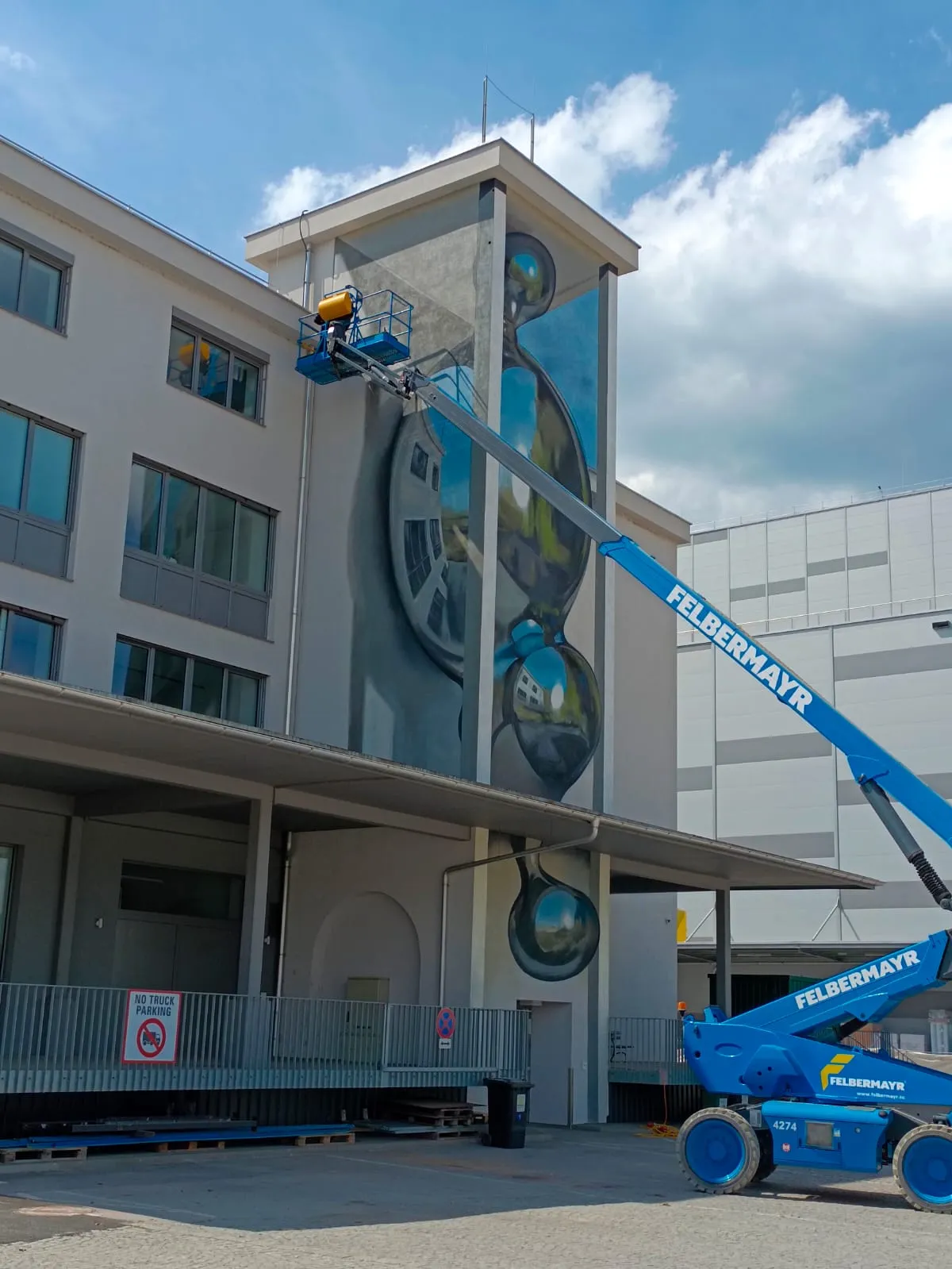 Odeith painting an anamorphic mural at Mural Harbor in Linz, Austria