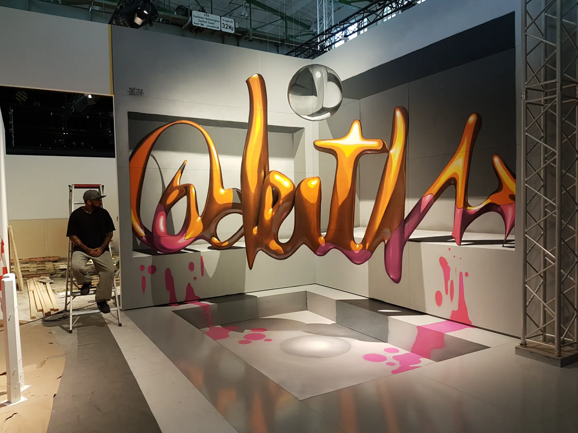 Final shot of the 4-meter high 3D anamorphic floating lettering mural painted across corner walls with recessed openings.