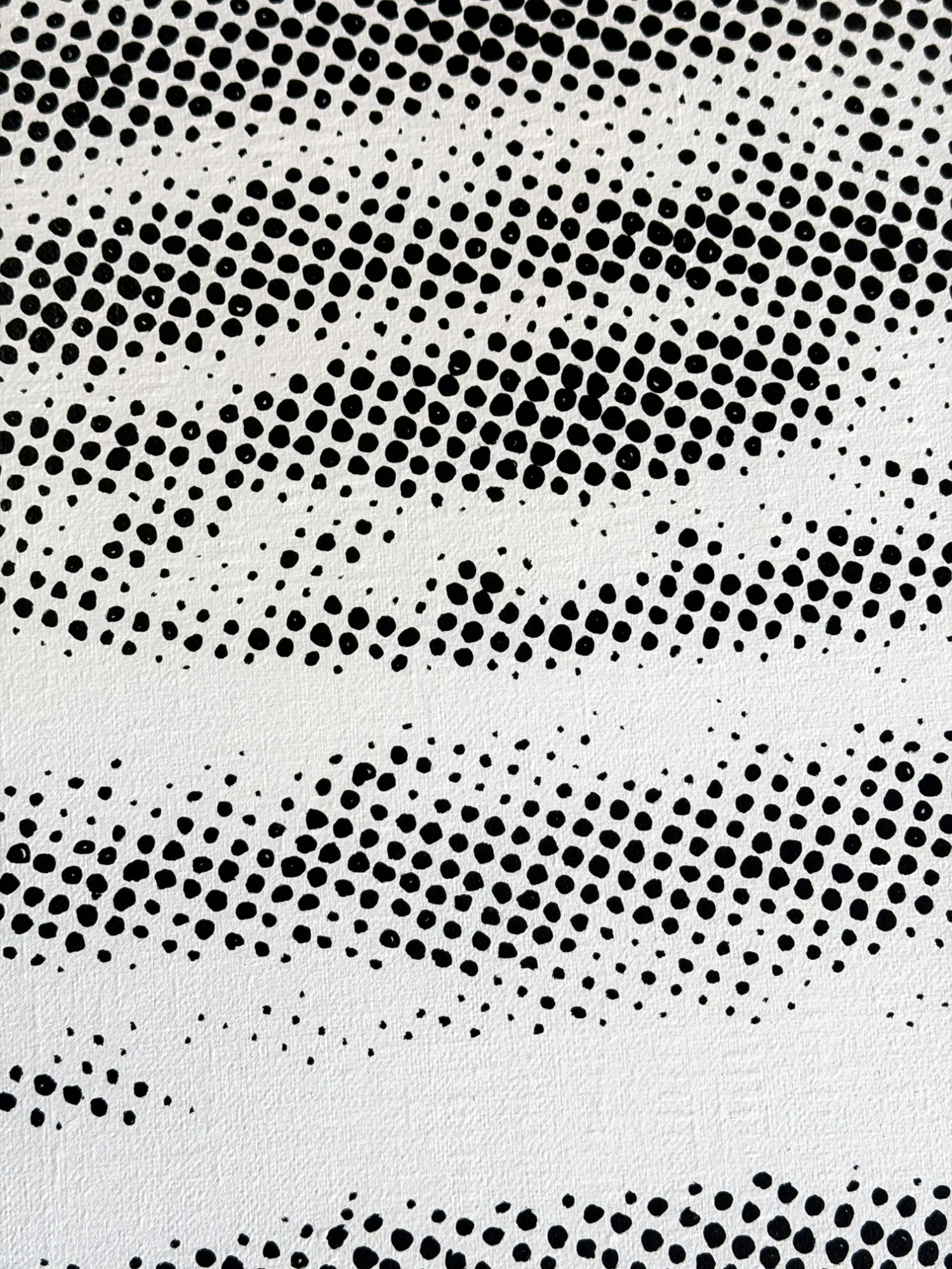 Close-up detail of black acrylic halftone dots painted on natural linen